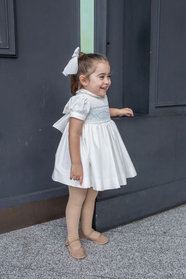 Naxos Ivory & Blue Hand Smocked Dress With Bow On The Back - 7622
